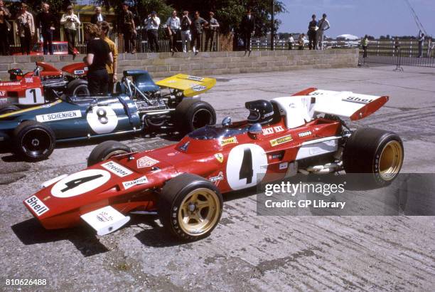 Jackie Ickx in a Ferrari 312T and Tim Schenken in a Brabham BT33 12th at Silverstone, British GP.