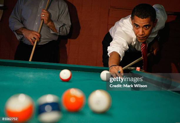 Democratic presidential hopeful Sen. Barack Obama plays a game of pool during a stop at Schultzie's Bar & Hot Spot May 12, 2008 in Springhill, West...