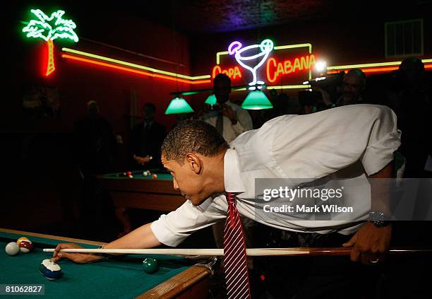 Democratic presidential hopeful Sen. Barack Obama plays a game of pool during a stop at Schultzie's Bar & Hot Spot May 12, 2008 in Springhill, West...