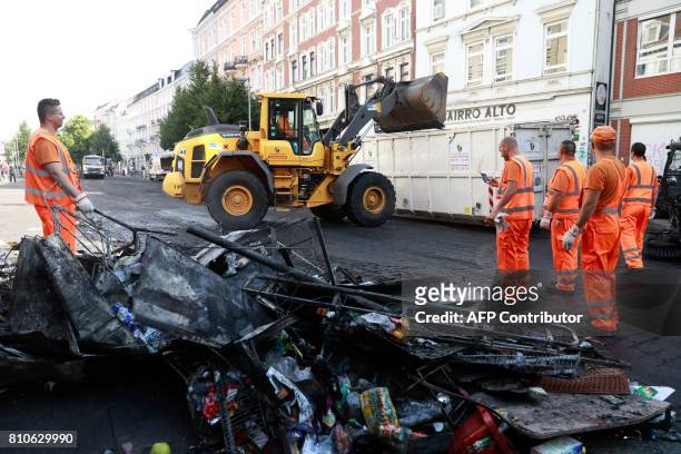 City cleaners remove debris after riots in Hamburg's Schanzenviertel district on July 8, 2017 in Hamburg, northern Germany, where leaders of the...