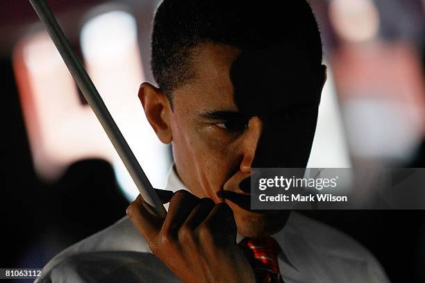 Democratic presidential hopeful Sen. Barack Obama contemplates his next shot while playing a game of pool during a stop at Schultzie's Bar & Hot Spot...