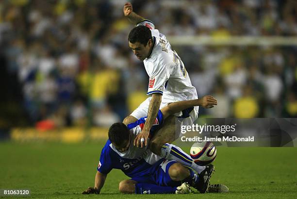 Andrew Hughes of Leeds tackles Evan Horwood of Carlisle during the League 1 Playoff Semi Final, 1st Leg match between Leeds United and Carlisle...
