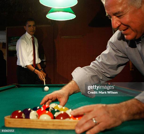 Democratic presidential hopeful Sen. Barack Obama watches as Rep. Nick Rahall racks the pool balls before playing a game of pool during a stop at...