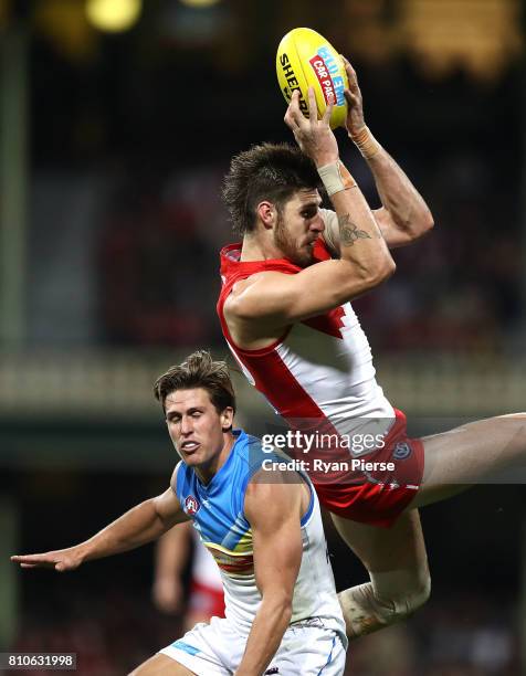 Sam Naismith of the Swans marks over David Swallow of the Suns during the round 16 AFL match between the Sydney Swans and the Gold Coast Suns at...