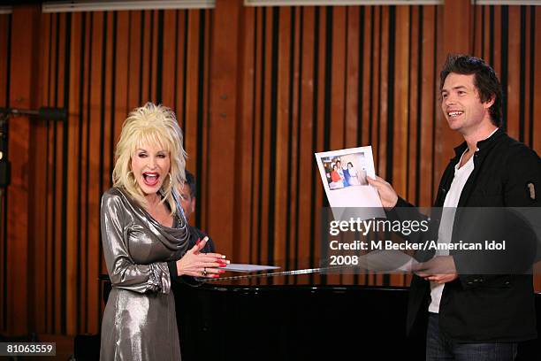 American Idol contestant Michael Johns rehearses in the studio with country singer Dolly Parton on March 29, 2008 in Los Angeles, California.