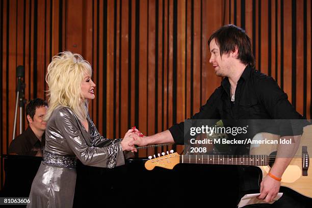 American Idol contestant David Cook rehearses in the studio with country singer Dolly Parton on March 29, 2008 in Los Angeles, California.