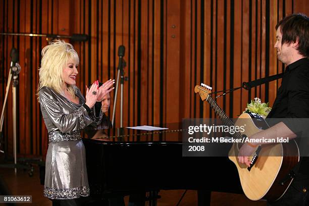 American Idol contestant David Cook rehearses in the studio with country singer Dolly Parton on March 29, 2008 in Los Angeles, California.