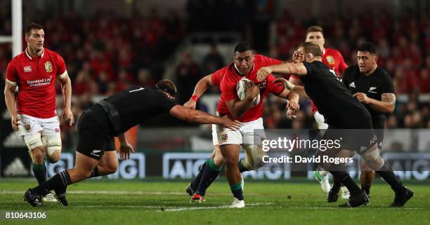 Mako Vunipola of the Lions is tackled by Joe Moody and Owen Franks of the All Blacks during the third test match between the New Zealand All Blacks...