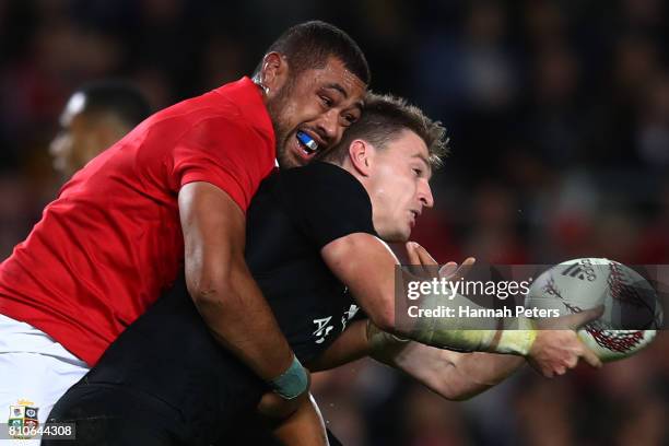 Beauden Barrett of the All Blacks offloads as he is tackled by Taulupe Faletau of the Lions during the third test match between the New Zealand All...