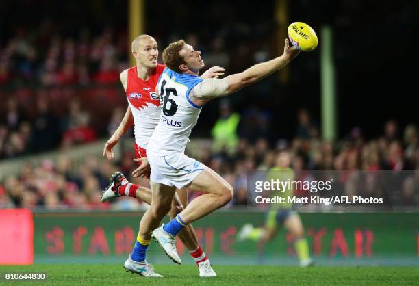 Rory Thompson of the Suns is challenged by Sam Reid of the Swans during the round 16 AFL match between the Sydney Swans and the Gold Coast Suns at...