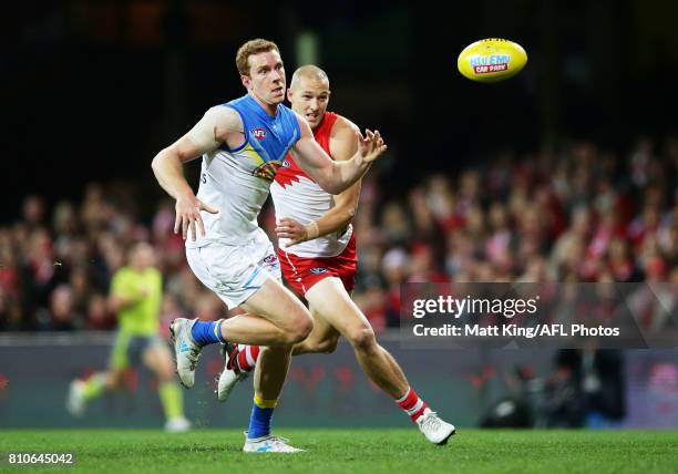 Rory Thompson of the Suns is challenged by Sam Reid of the Swans during the round 16 AFL match between the Sydney Swans and the Gold Coast Suns at...