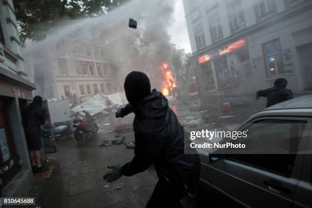 Riot police use water cannons during protests in Hamburg's Schanzenviertel district during the G20 summit in Hamburg, Germany, on July 7, 2017.