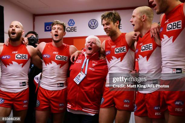 Kenny Williams sings the team song with Swans players Jarrad McVeigh, Luke Parker, Dane Rampe and Zak Jones after the round 16 AFL match between the...