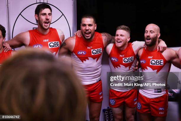 Sam Naismith, Lance Franklin, Daniel Hannebery and Jarrad McVeigh of the Swans sing the club song after the round 16 AFL match between the Sydney...