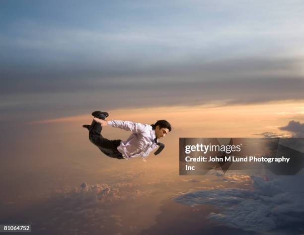 hispanic businessman flying in air - person falling mid air stock pictures, royalty-free photos & images