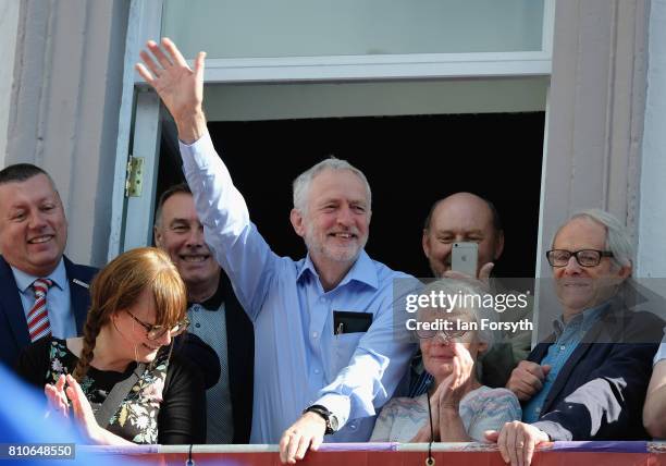 Leader of the Labour Party, Jeremy Corbyn waves to crowds as he stands with film director Ken Loach as they watch colliery bands pass below the...