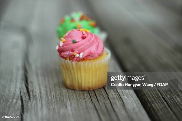 cup cake on wooden table - candy wang stock pictures, royalty-free photos & images