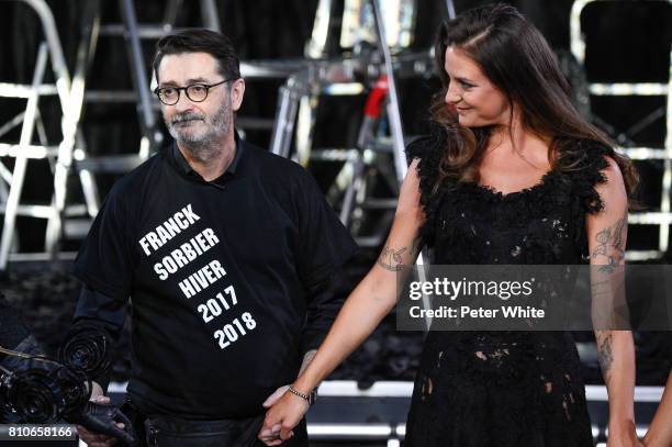 Designer Franck Sorbier and the Godmother of the Collection, daughter of Lio singer, Nubia Esteban acknowledge the audience after the Franck Sorbier...