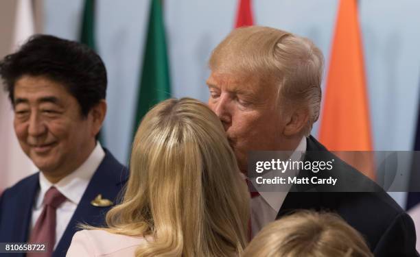 President Donald Trump kisses his daughter Ivanka Trump at a panel discussion titled 'Launch Event Women's Entrepreneur Finance Initiative' on the...