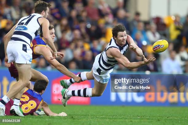 Patrick Dangerfield of the Cats handballs during the round 16 AFL match between the Brisbane Lions and the Geelong Cats at The Gabba on July 8, 2017...