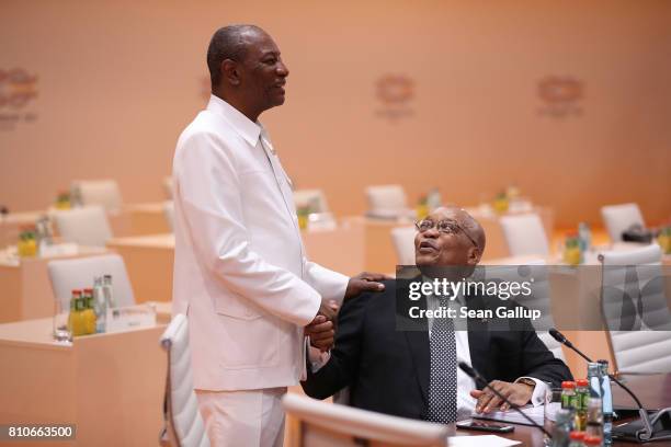 Chairman of the African Union Alpha Conde and South Afrcian President Jacob Zuma chat prior to the morning working session on the second day of the...