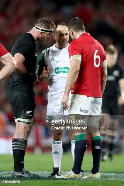 Referee Romain Poite speaks with All Black captain Kieran Read and Lions captain Sam Warburton as he downgrades a call made in the final minutes from...