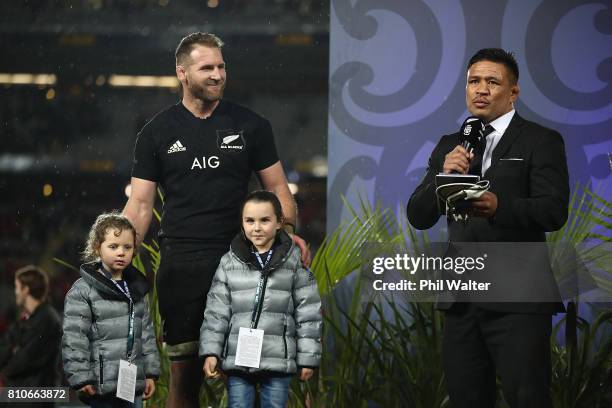 All Black captain Kieran Read stands with his children on stage as he is awarded his 100th test cap from Keven Mealamu following the Test match...