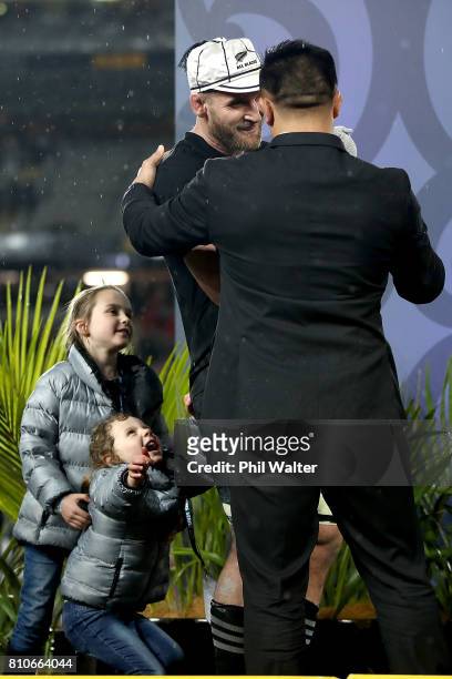 All Black captain Kieran Read stands with his children on stage as he is awarded his 100th test cap from Keven Mealamu following the Test match...