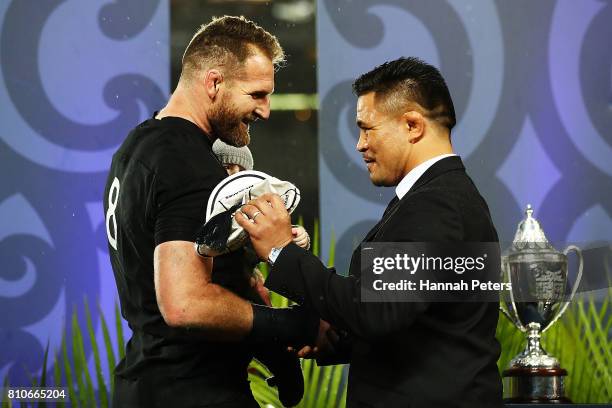 Kieran Read of the All Blacks receives his 100th cap from former All Blacks player Keven Mealamu after drawing the Test match between the New Zealand...