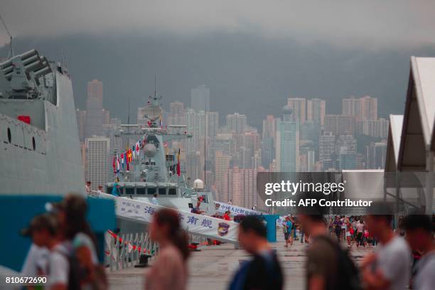Visitors board the Chinese People's Liberation Army Navy destroyer Jinan and frigate Huizhou at the Ngong Shuen Chau naval base on Stonecutters...