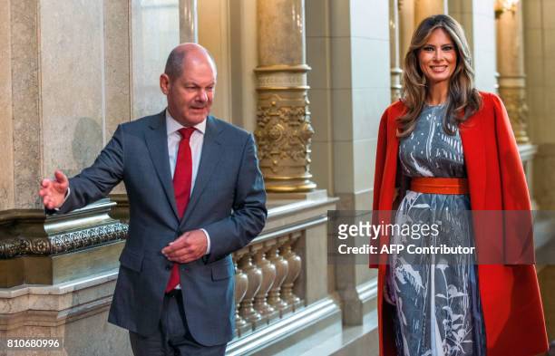 Hamburg's mayor Olaf Scholz greets US First Lady Melania Trump as she arrives to attend the partners' programme at the city hall during the G20...
