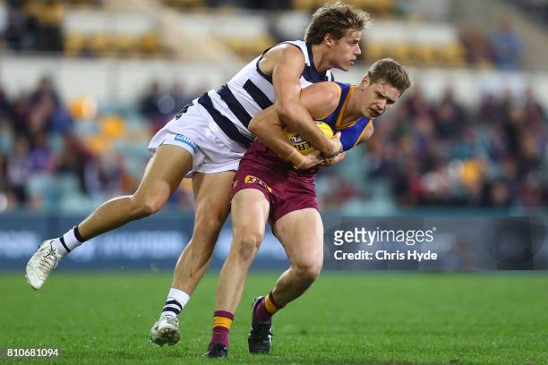Matthew Hammelmann of the Lions is tackled by Jake Kolodjashnij of the Cats during the round 16 AFL match between the Brisbane Lions and the Geelong...