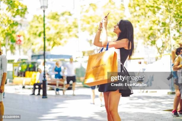 shopping woman, barcelona - spain - bag vuitton stock pictures, royalty-free photos & images