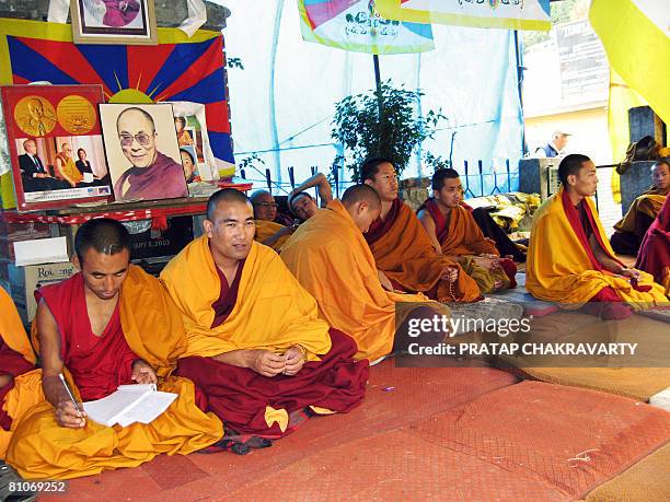 Tibetan monks chant from holy Buddhist scriptures at a relay hunger strike near the Dalai Lama's palace in Dharamsala on May 13, 2008 to protest...