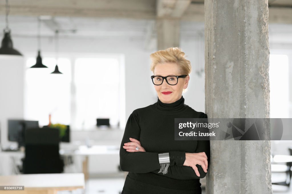Portrait of elegant senior businesswoman in the modern studio