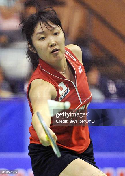 Satoko Suetsuna of Japan returns the shuttlecock to Lim Pek Siah of Malaysia during their woman's singles match at the Uber Cup badminton tournament...