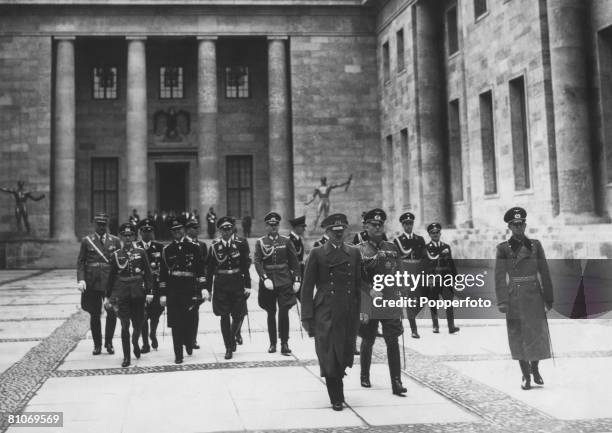 Nazi leader Adolf Hitler shows a group of military officers around the New Reich Chancellery, Berlin, 1939. The newly-built Chancellery was designed...