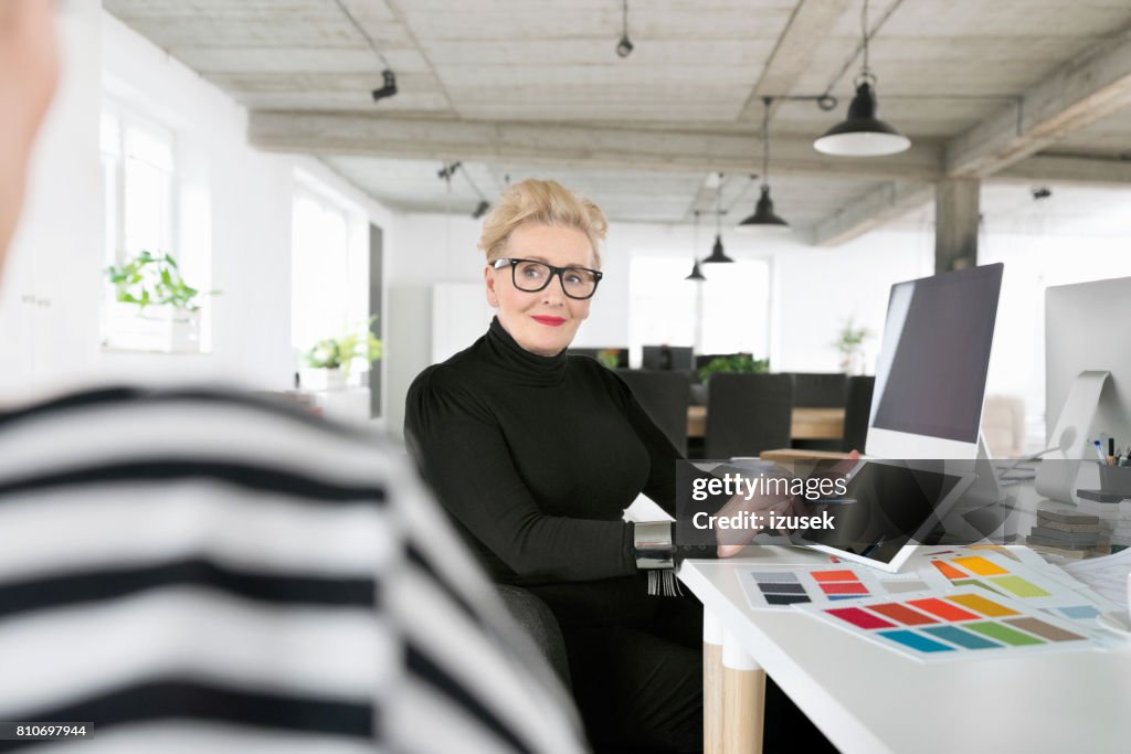 Senior businesswoman using a digital tablet in the office