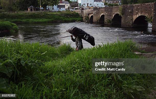 Bernard Thomas walks to the river bank to check his recently repaired traditional coracle boat for leaks as he prepares for one of his final nights...