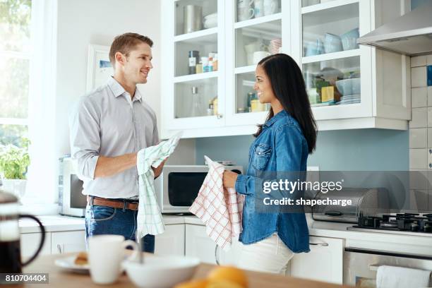 housework is their shared responsibility - mid adult couple stock pictures, royalty-free photos & images