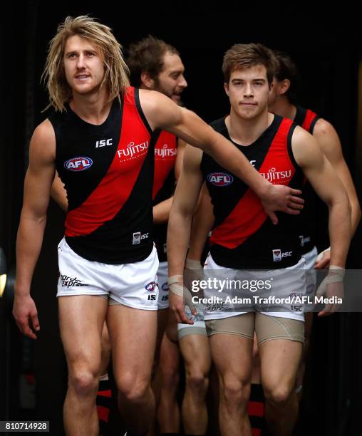 Dyson Heppell and Zach Merrett of the Bombers come up the race during the 2017 AFL round 16 match between the Collingwood Magpies and the Essendon...