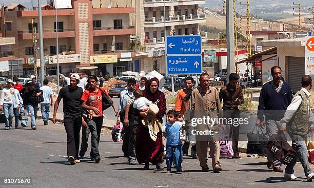 Syrians and Lebanese cross by foot the Lebanese-Syrian border at al-Masnaa crossing point in the Bekaa valley east Lebanon, on May 13, 2008....