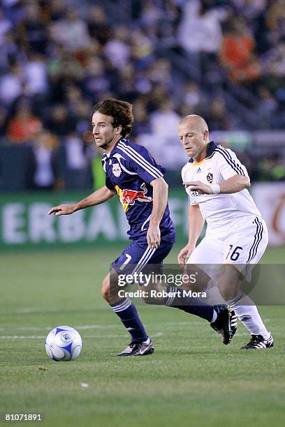 Mike Magee pushes the ball past Joe Franchino of the Los Angeles Galaxy during the MLS game against the New York Red Bulls at Home Depot Center on...