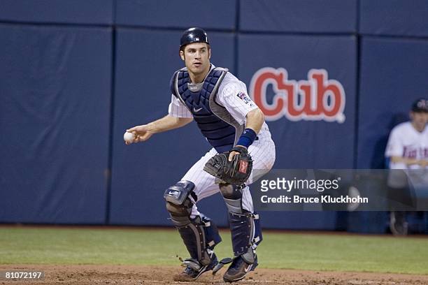 Joe Mauer of the Minnesota Twins throws to first in a game against the Boston Red Sox at the Humphrey Metrodome in Minneapolis, Minnesota on May 9,...