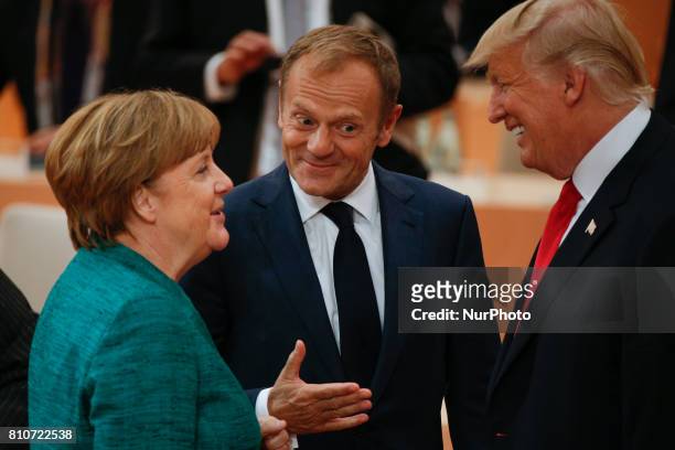 President Donald Trump is seen with European Council president Donald Tusk and German chancellor Angela Merkel ahead of the thrid plenary session of...