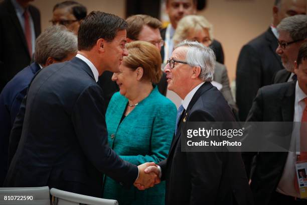 Dutch PM Mark Rutte shakes hands with European Commission president Jean-Claude Juncker ahead of the plenary session at the G20 summit on 8 July,...