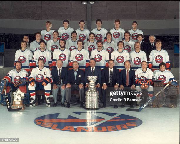 Publicity portrait of the New York Islanders, players and management, posed on the ice as a team with the Stanley Cup, 1983.