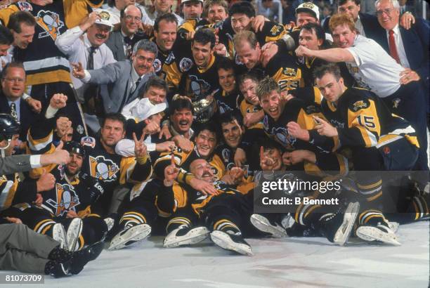 Team members and staff from the Pittsburgh Penguins ice hockey team pose together on the ice following their victory over the Chicago Blackhawks in...