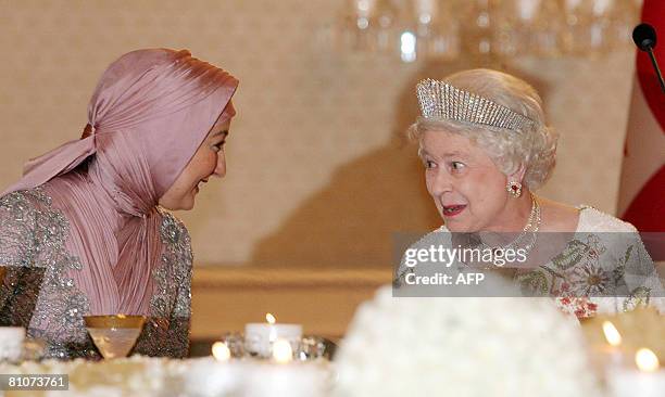 Britain's Queen Elizabeth and Turkish President Abdullah Gul's wife Hayrunnisa Gul talk during a dinner at the Presidential Palace in Ankara May 13,...