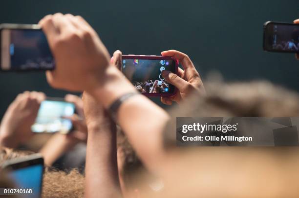 Music fans using their phones in the crowd as Kendrick Lamar performs onstage headlining Day 2 of the 50th Festival D'ete De Quebec on the main stage...